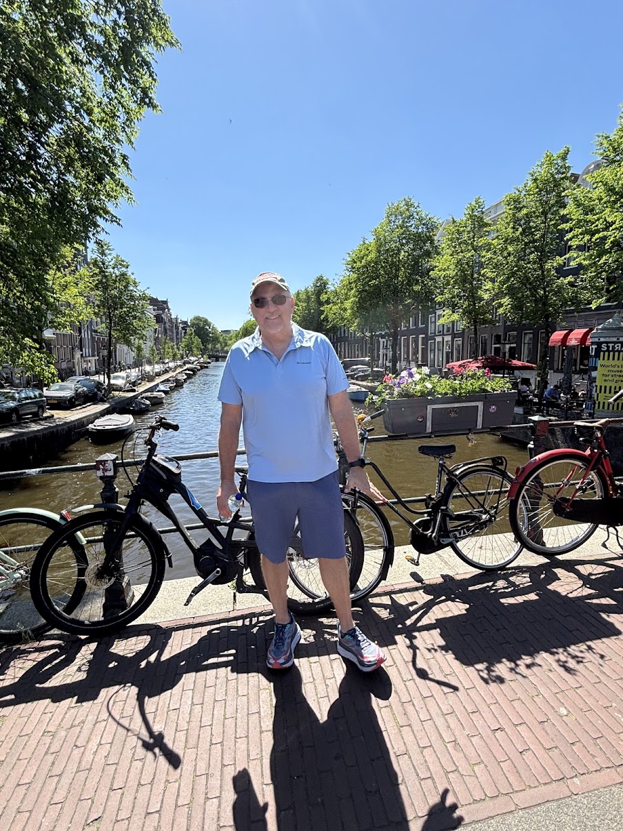 Mike on Amsterdam canal bridge with bikes