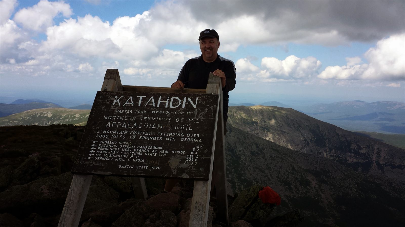 Mike at the Katahdin summit sign, northern terminus of the Appalachian Trail, 2013