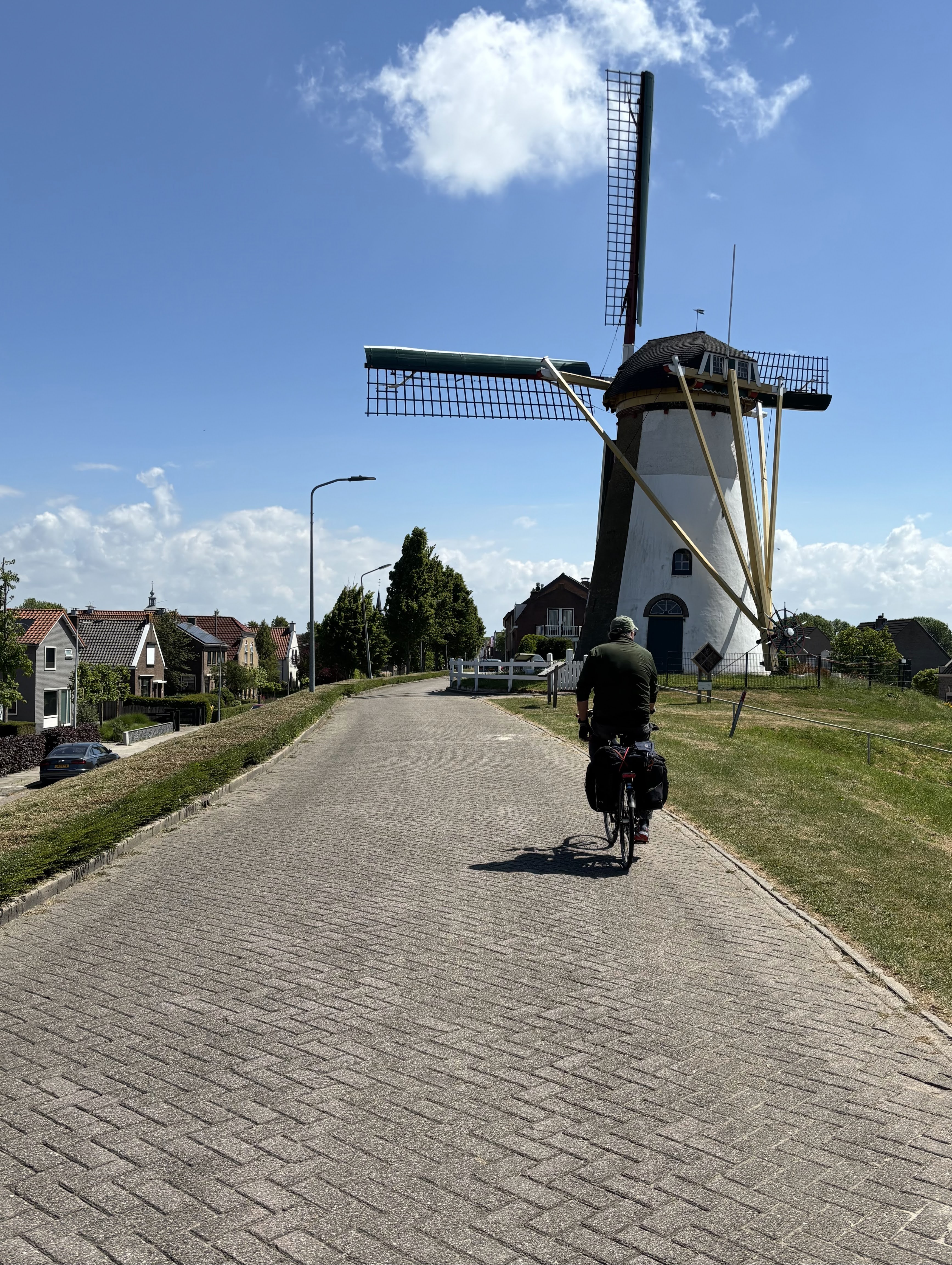 Mike cycling past a windmill