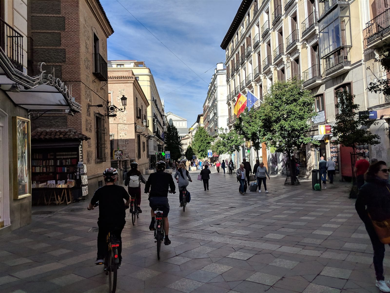 Cyclists on a pedestrian street in old Madrid