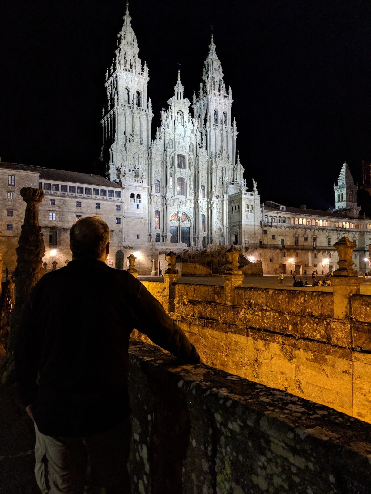 Looking out at the floodlit Santiago cathedral across an empty square at night