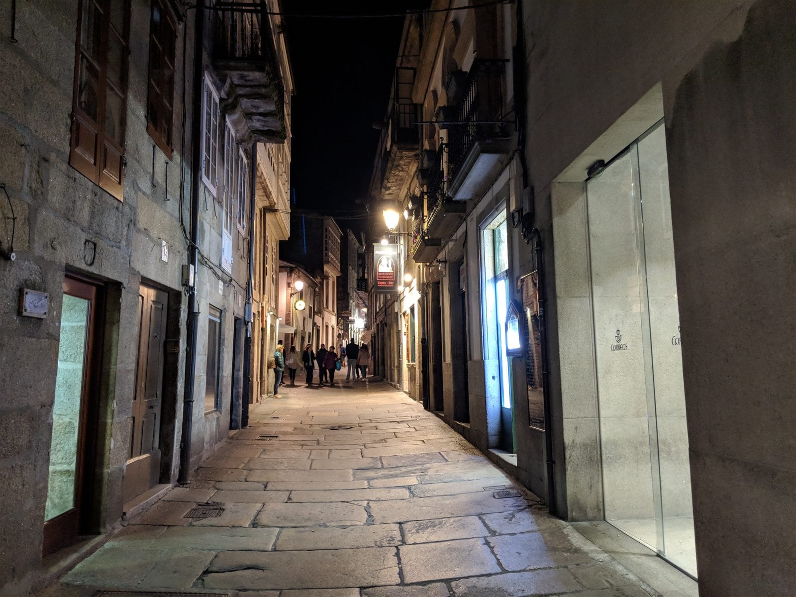 A quiet lamplit street in Santiago's old town at night