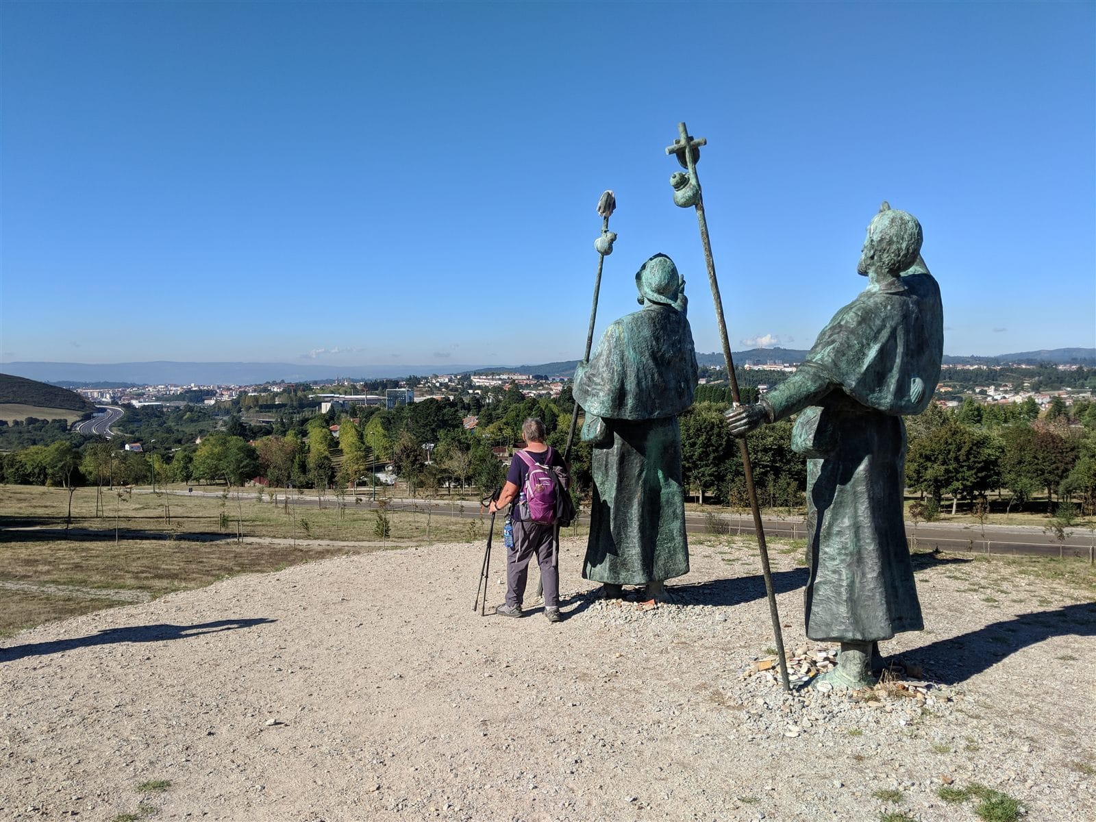 Bronze pilgrim statues at Monte do Gozo pointing toward Santiago