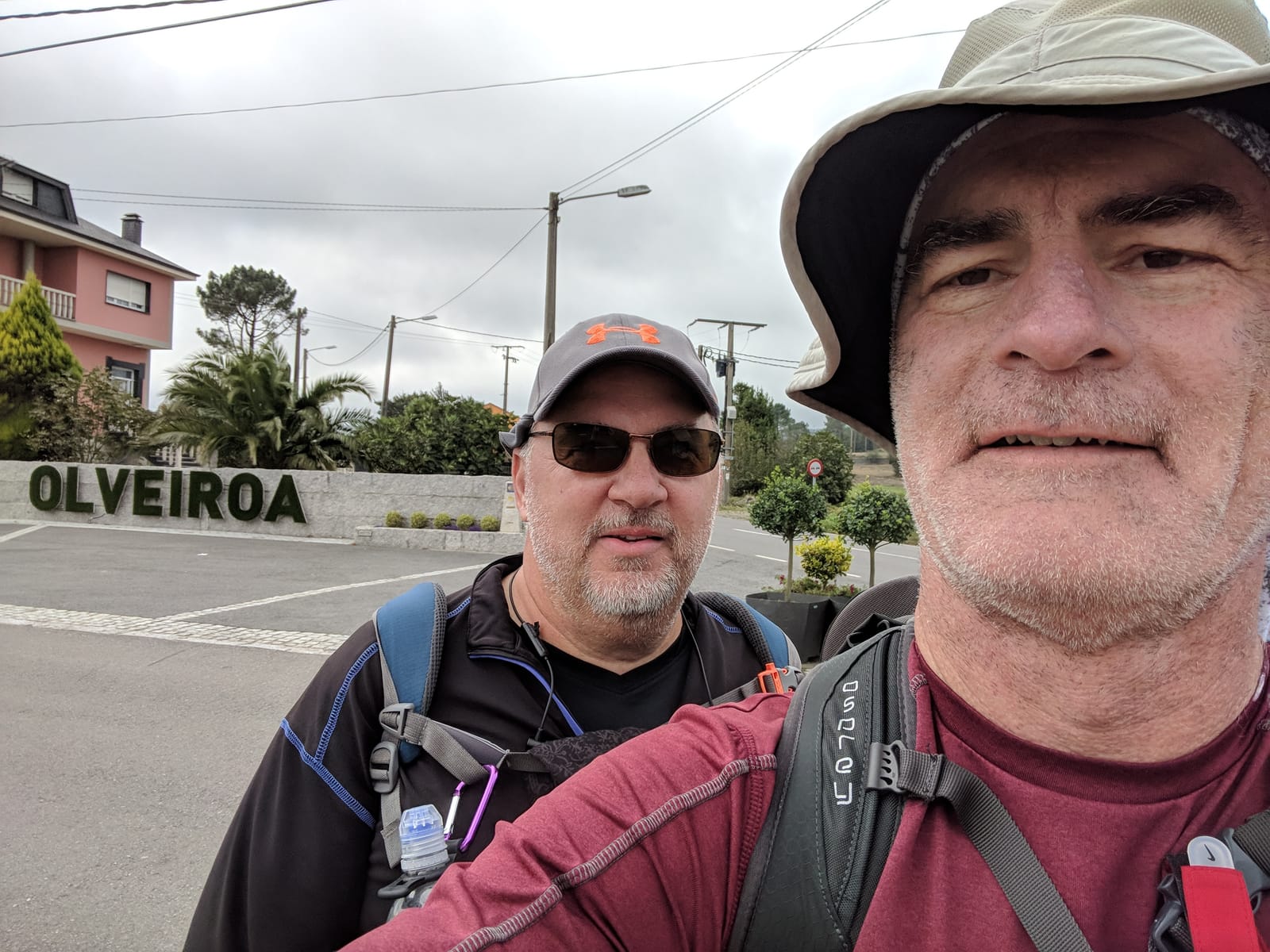 Mike and Doug taking a selfie at the OLVEIROA village sign