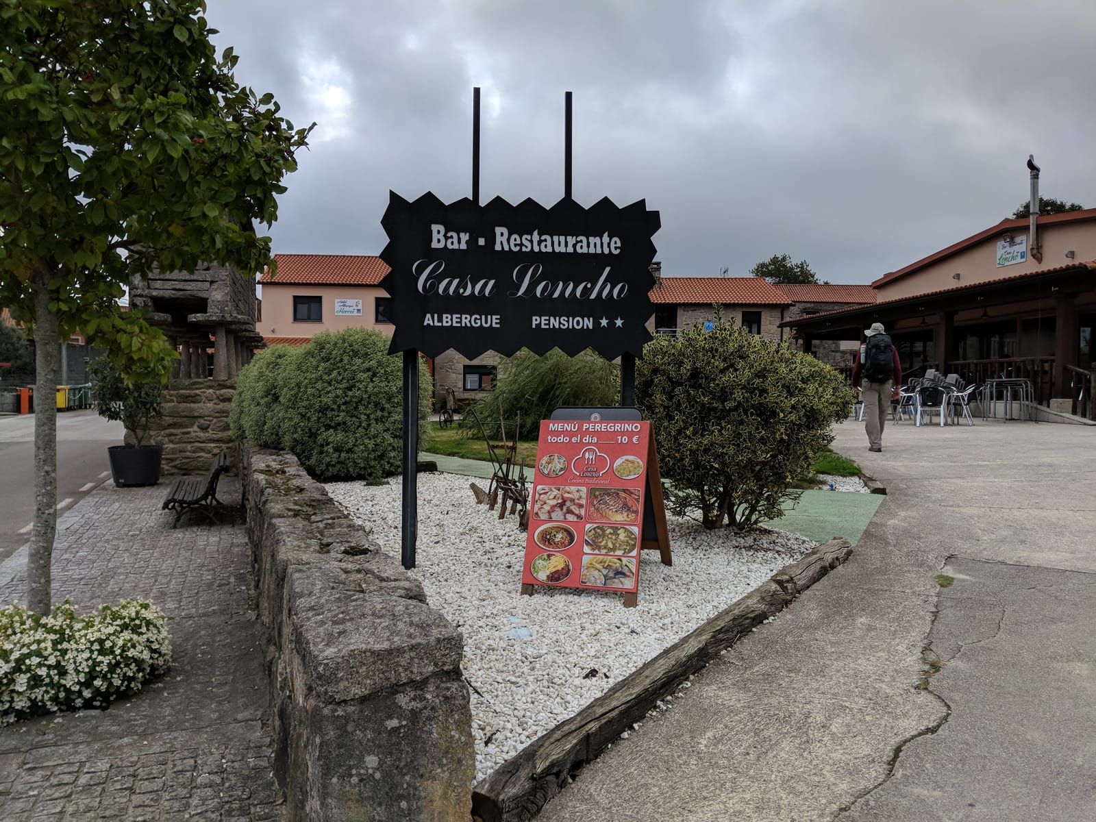 Casa Loncho bar-restaurante sign advertising a 10 euro menú peregrino in Olveiroa