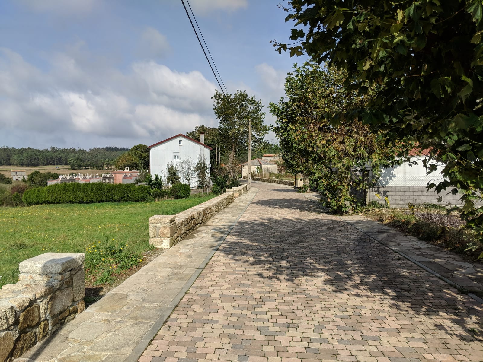 Cobbled village lane past a cemetery