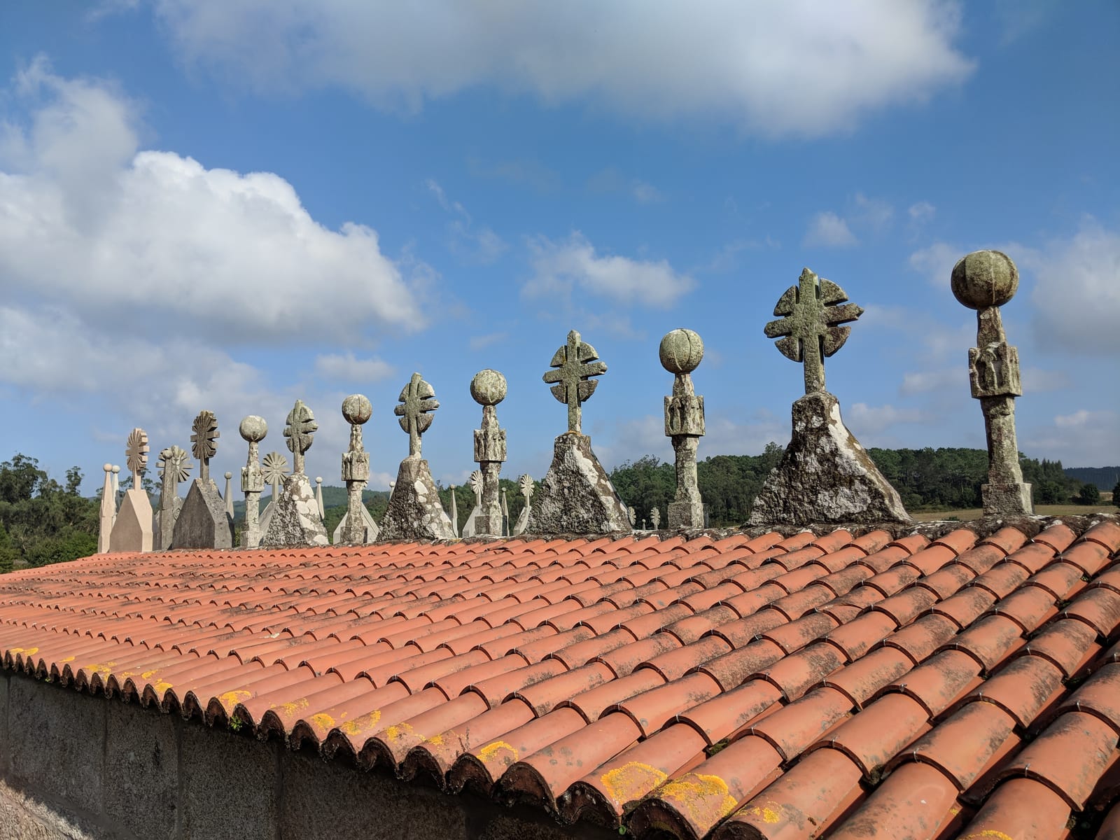 Ornate stone crosses along a church roofline