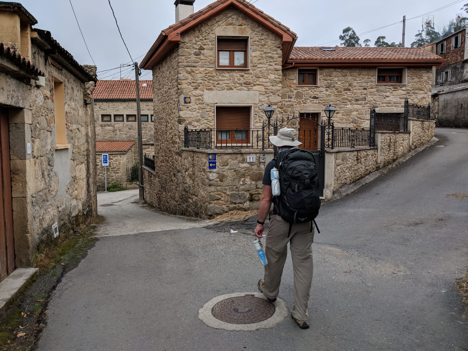 Doug walking through a granite Galician village