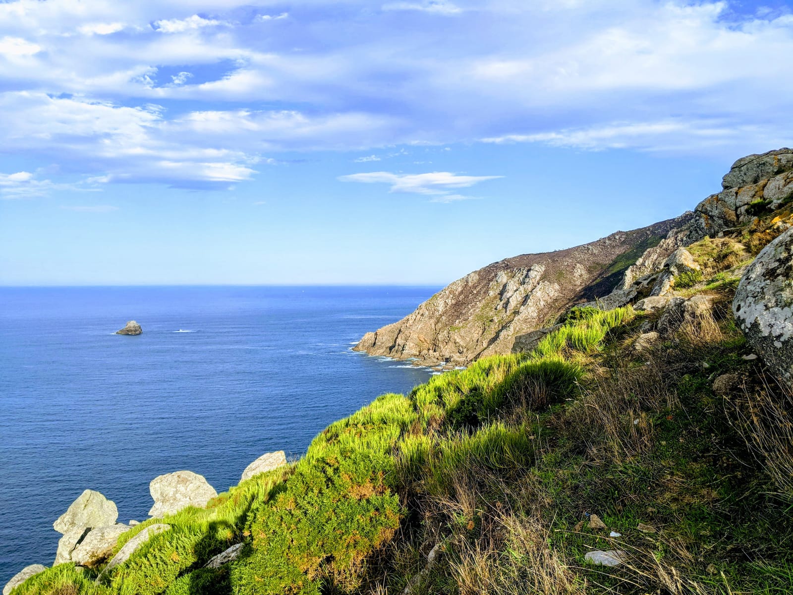 Vivid blue Atlantic and green cliffs at Cape Finisterre