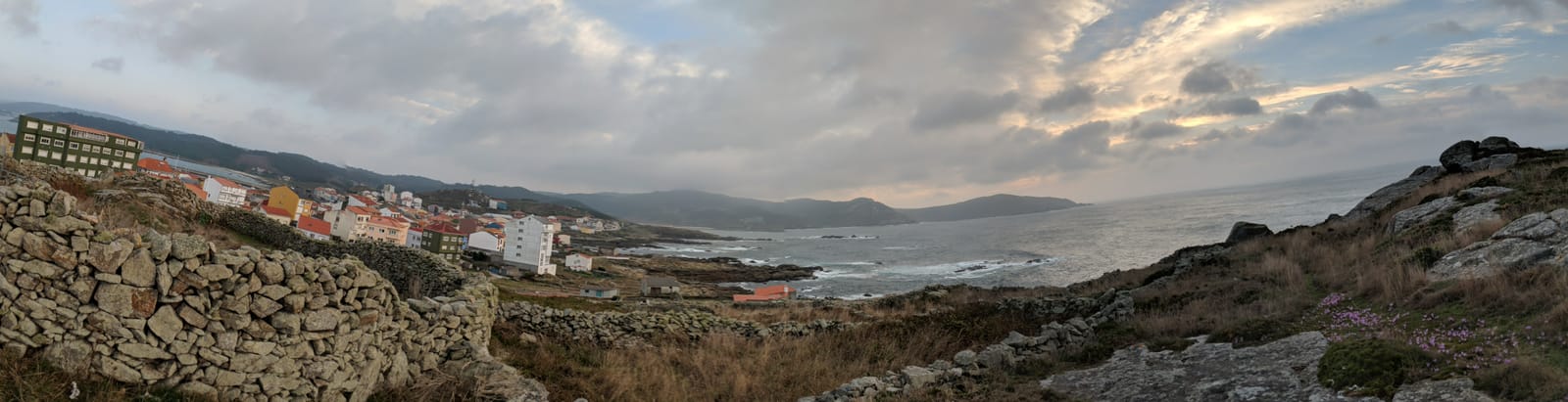 Panorama of Muxía, its bay and the surrounding hills at dusk