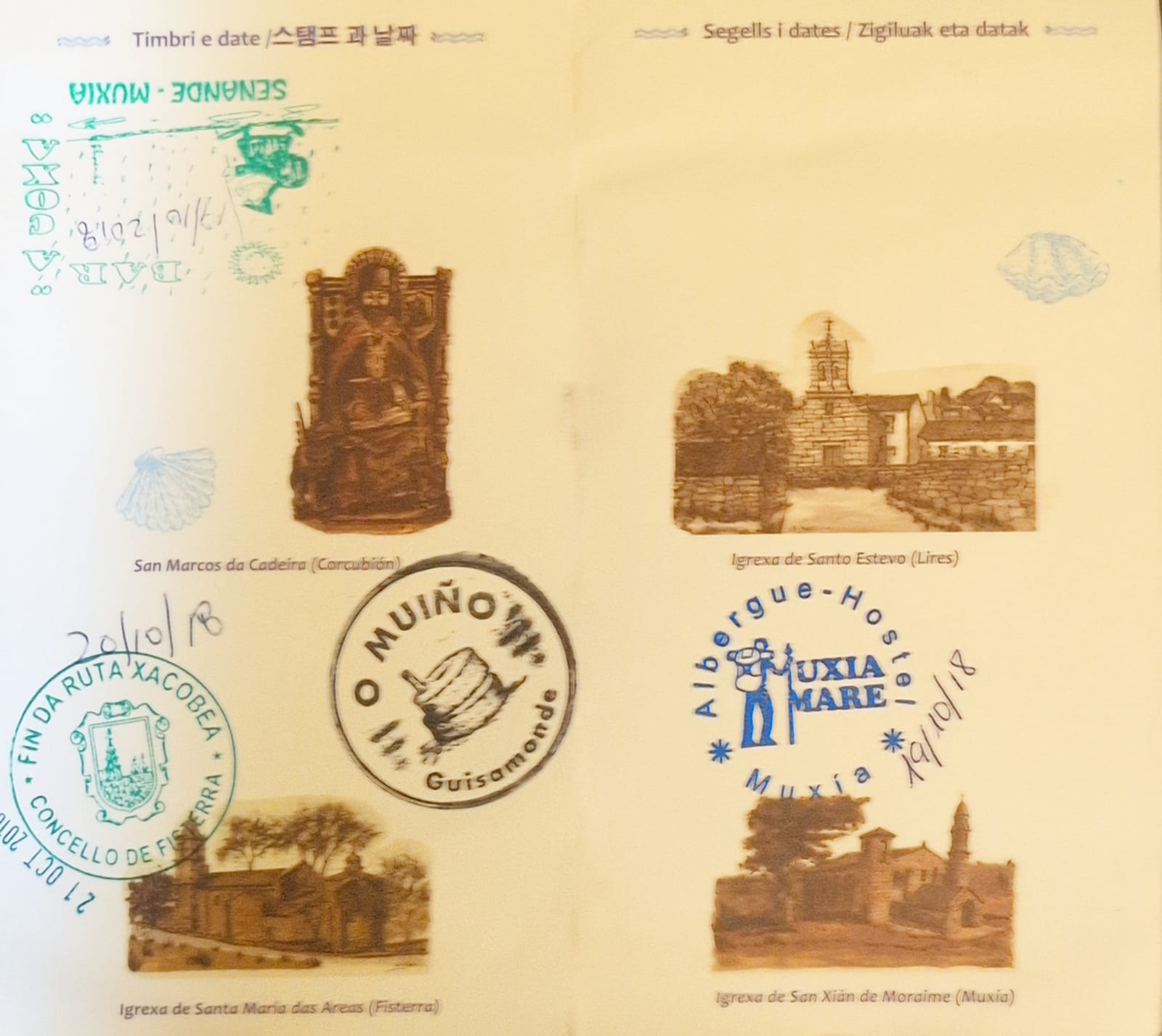 Pilgrim credential stamps including the Fisterra end-of-route seal