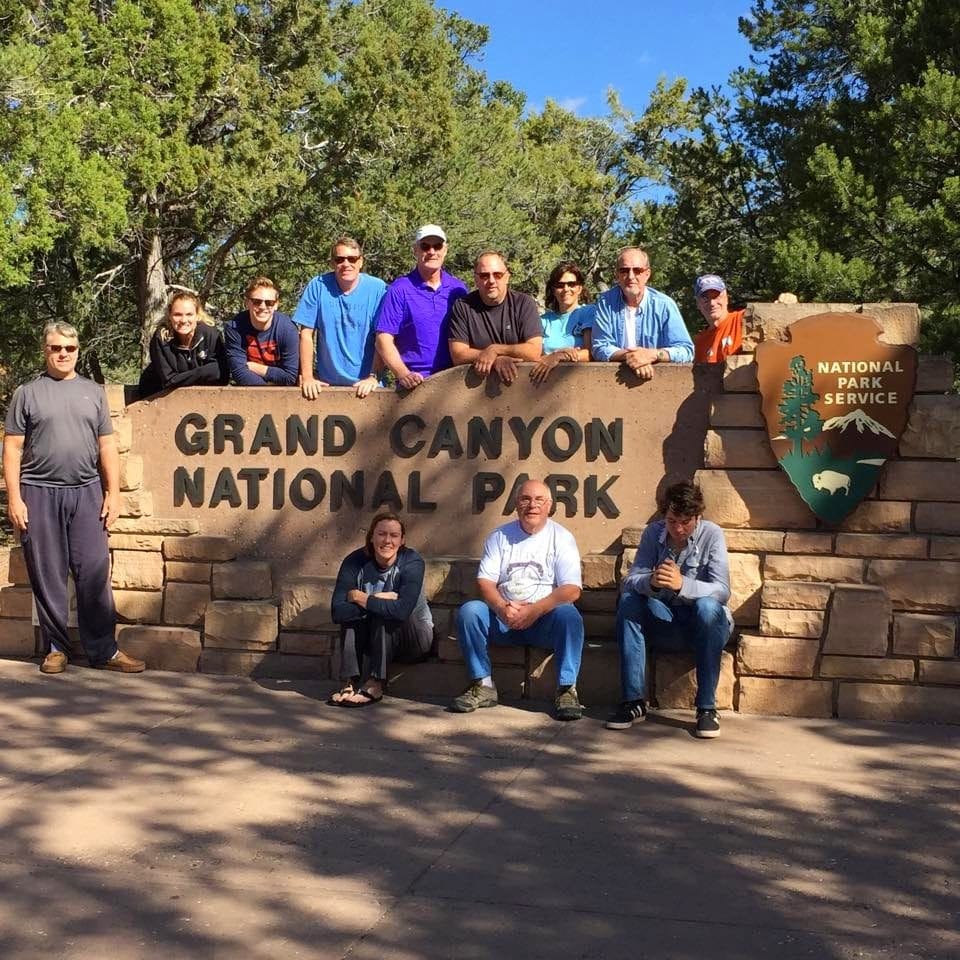 Rim-to-rim hiking group at the Grand Canyon National Park sign