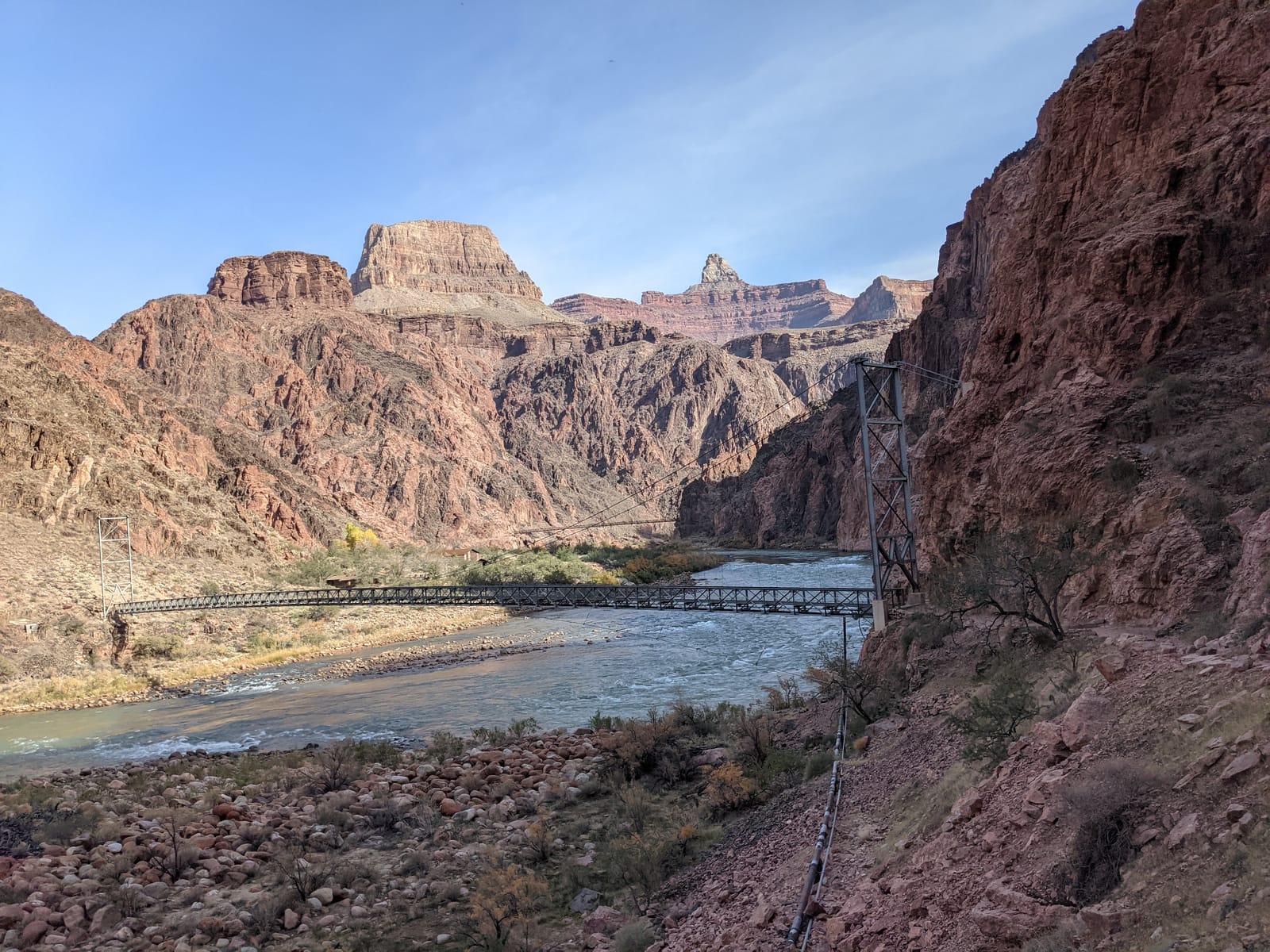 The Silver Bridge suspended over the green Colorado River in the Grand Canyon