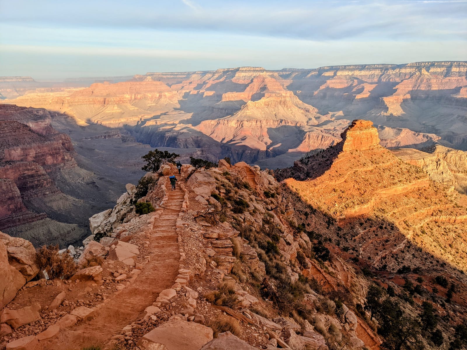 The South Kaibab Trail descending along a ridge into the Grand Canyon in golden morning light