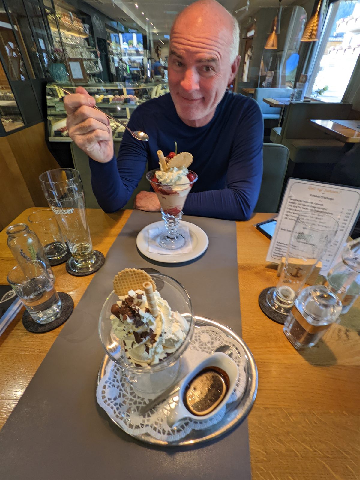 Doug about to dig into two elaborate ice cream sundaes at the dinner table
