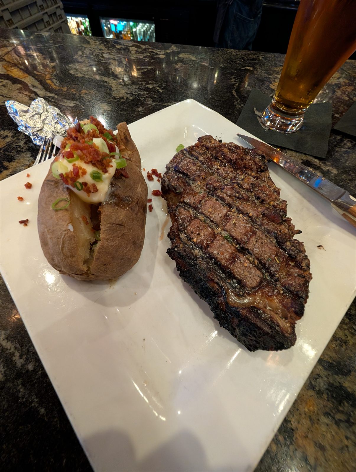 Steak, salad, and baked potato dinner in Missoula